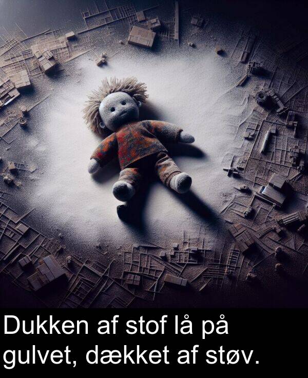 gulvet: Dukken af stof lå på gulvet, dækket af støv.