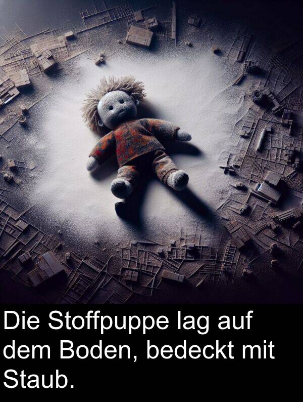 dem: Die Stoffpuppe lag auf dem Boden, bedeckt mit Staub.