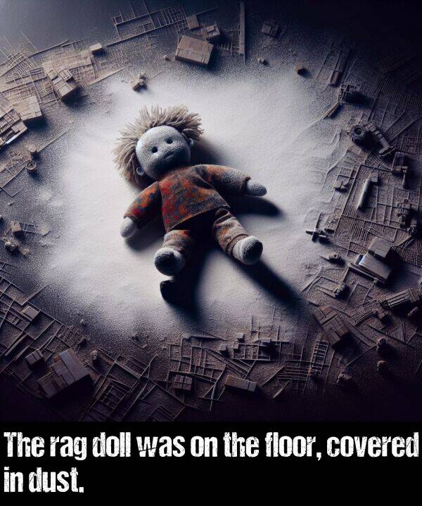 covered: The rag doll was on the floor, covered in dust.