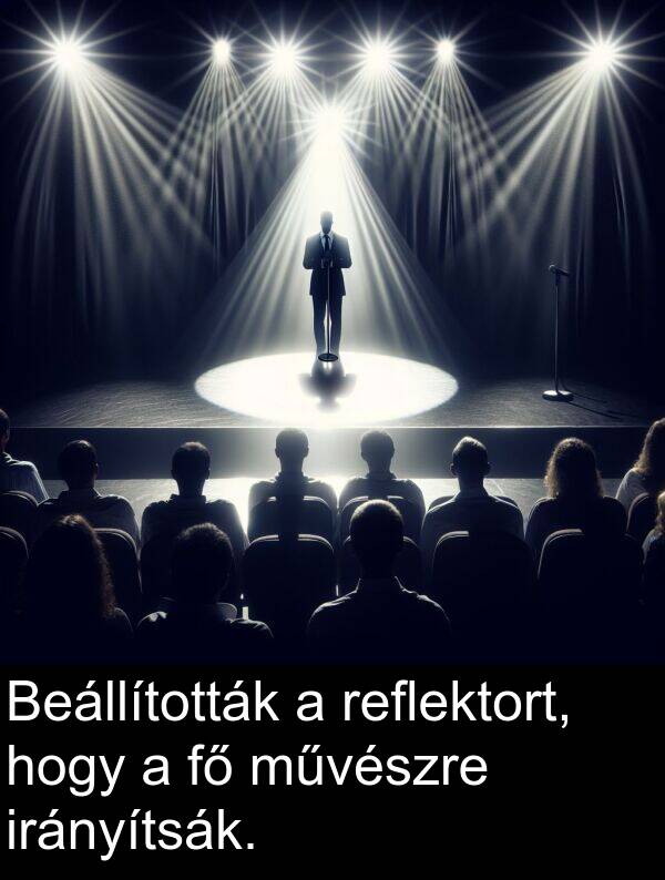 művészre: Beállították a reflektort, hogy a fő művészre irányítsák.