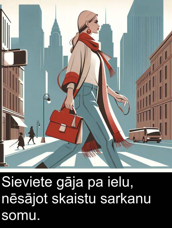 skaistu: Sieviete gāja pa ielu, nēsājot skaistu sarkanu somu.