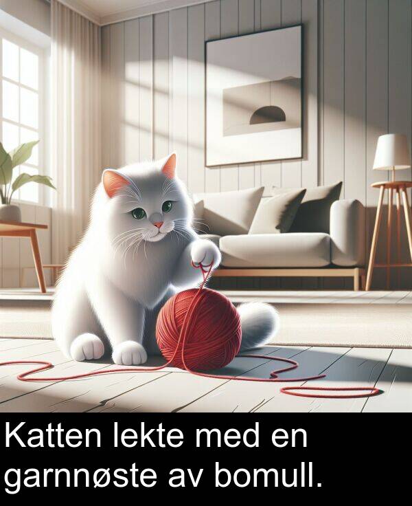 lekte: Katten lekte med en garnnøste av bomull.
