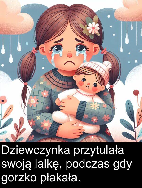 płakała: Dziewczynka przytulała swoją lalkę, podczas gdy gorzko płakała.