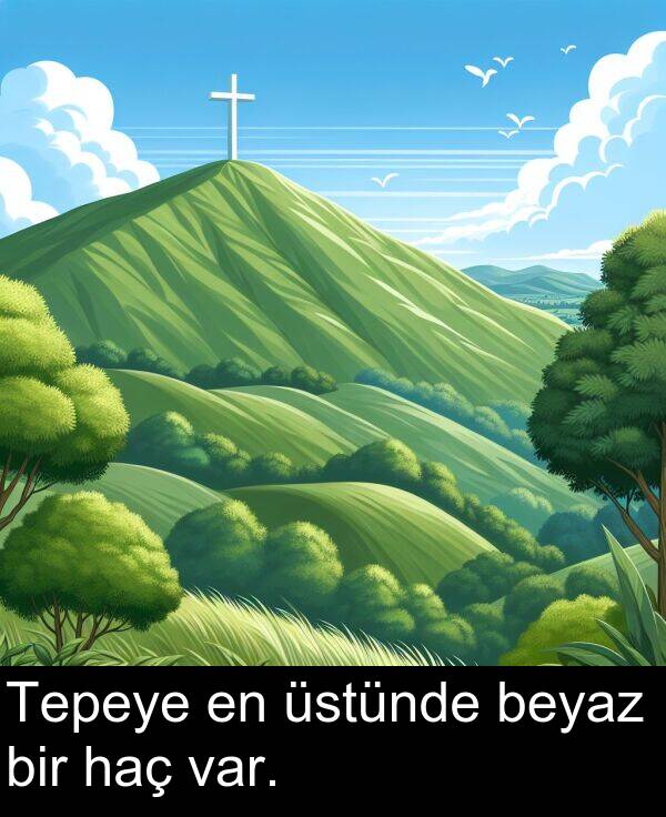 var: Tepeye en üstünde beyaz bir haç var.