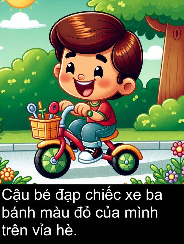bánh: Cậu bé đạp chiếc xe ba bánh màu đỏ của mình trên vỉa hè.