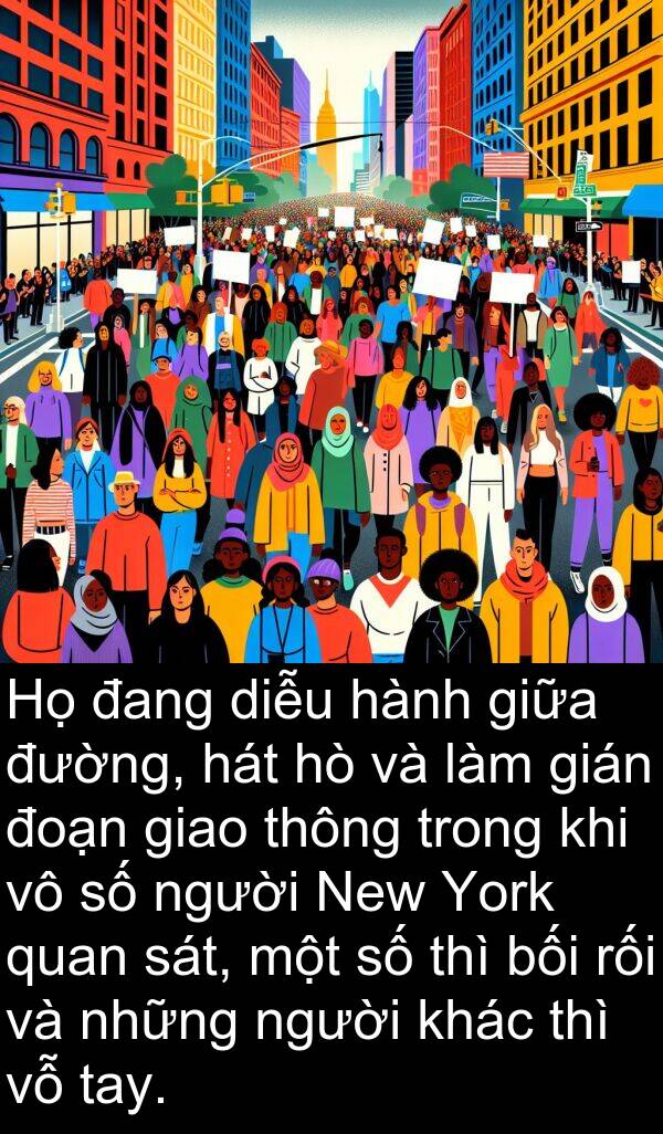 bối: Họ đang diễu hành giữa đường, hát hò và làm gián đoạn giao thông trong khi vô số người New York quan sát, một số thì bối rối và những người khác thì vỗ tay.